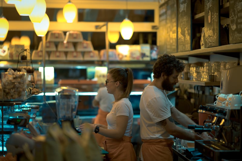 A photo of staff working within a cafe A photo of staff working within a cafe